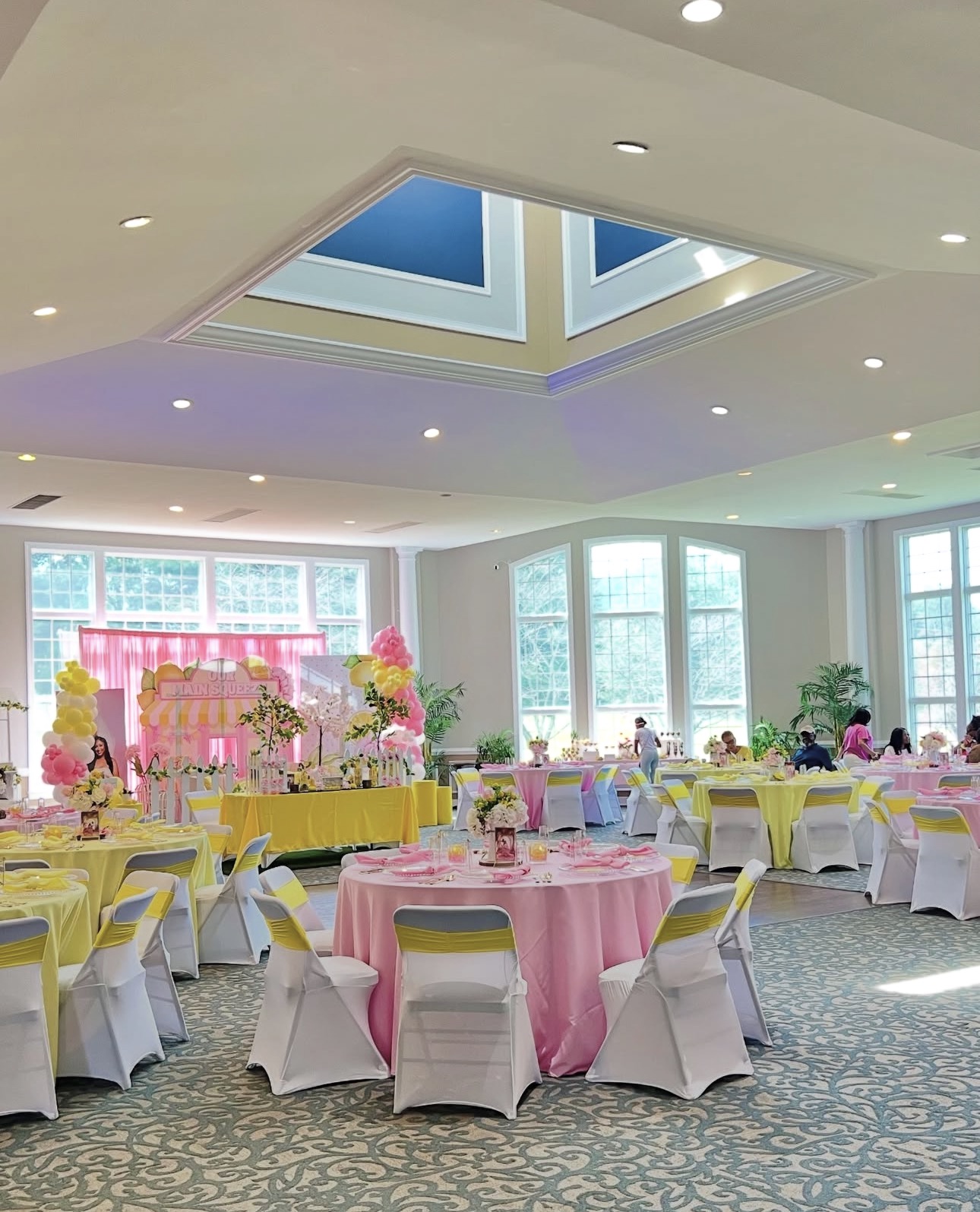 Elegant ballroom event setup with custom backdrop and table styling