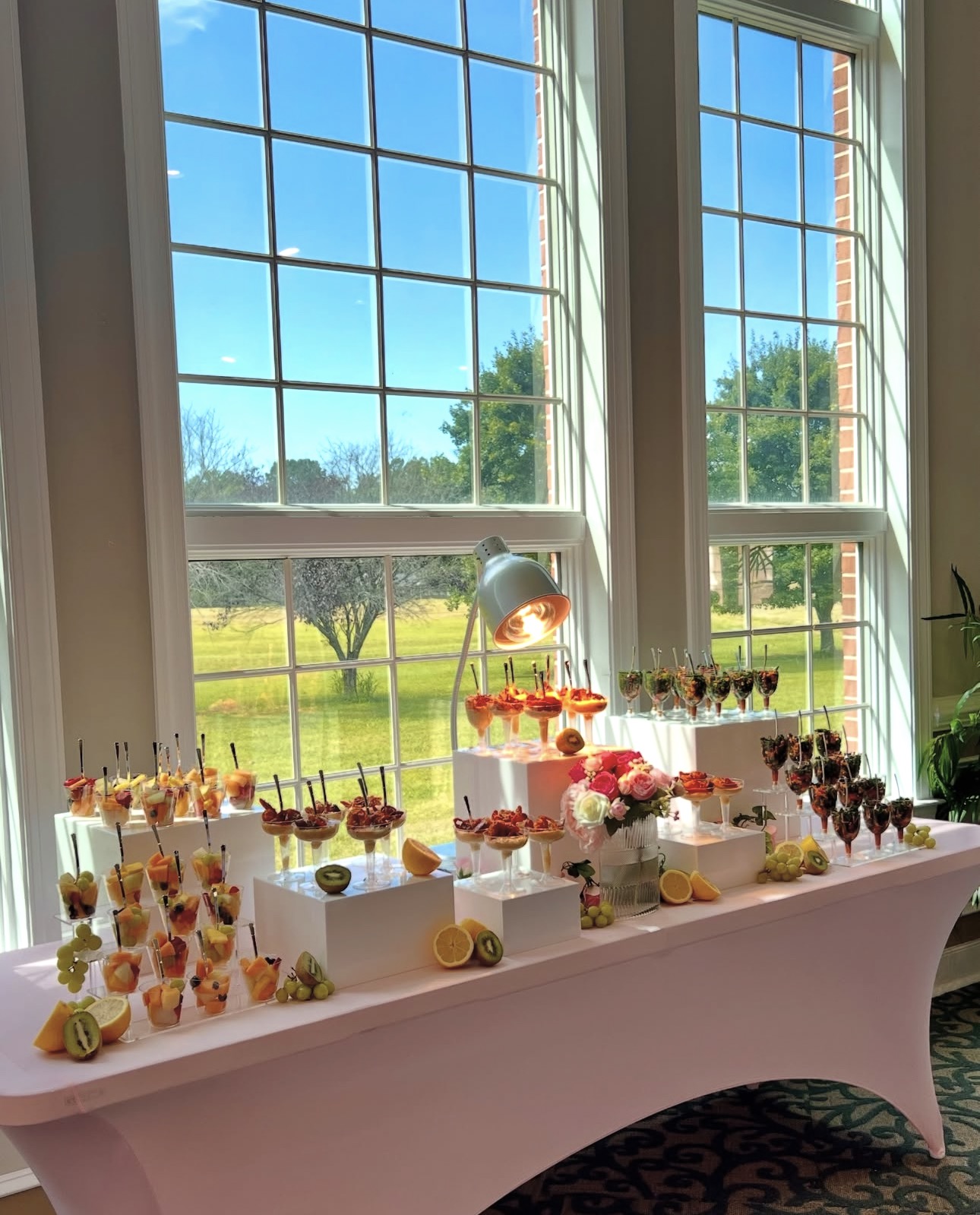 Elegant pink catering display with fresh fruit