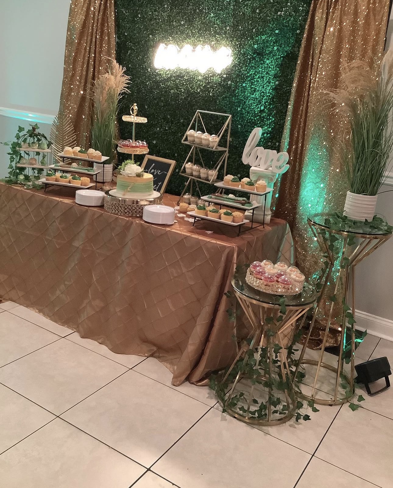 Wedding dessert station with hedge wall backdrop